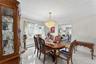 Dining area featuring a prominent crystal chandelier and tile flooring