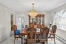 Dining area featuring a central crystal chandelier, tiled flooring, and neutral wall tones