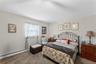 Neutral-toned walls complement the carpeted flooring