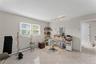 Spacious interior with neutral wall tones and light-toned square tile flooring
