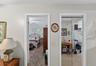 Interior doorway leading to a carpeted room with a ceiling fan