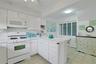 The doors here in the Kitchen go to the Laundry area which offers additional storage space as well.