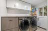Main Level Laundry with New Washer and Dryer with built in Laundry sorter and lots of storage and work area.