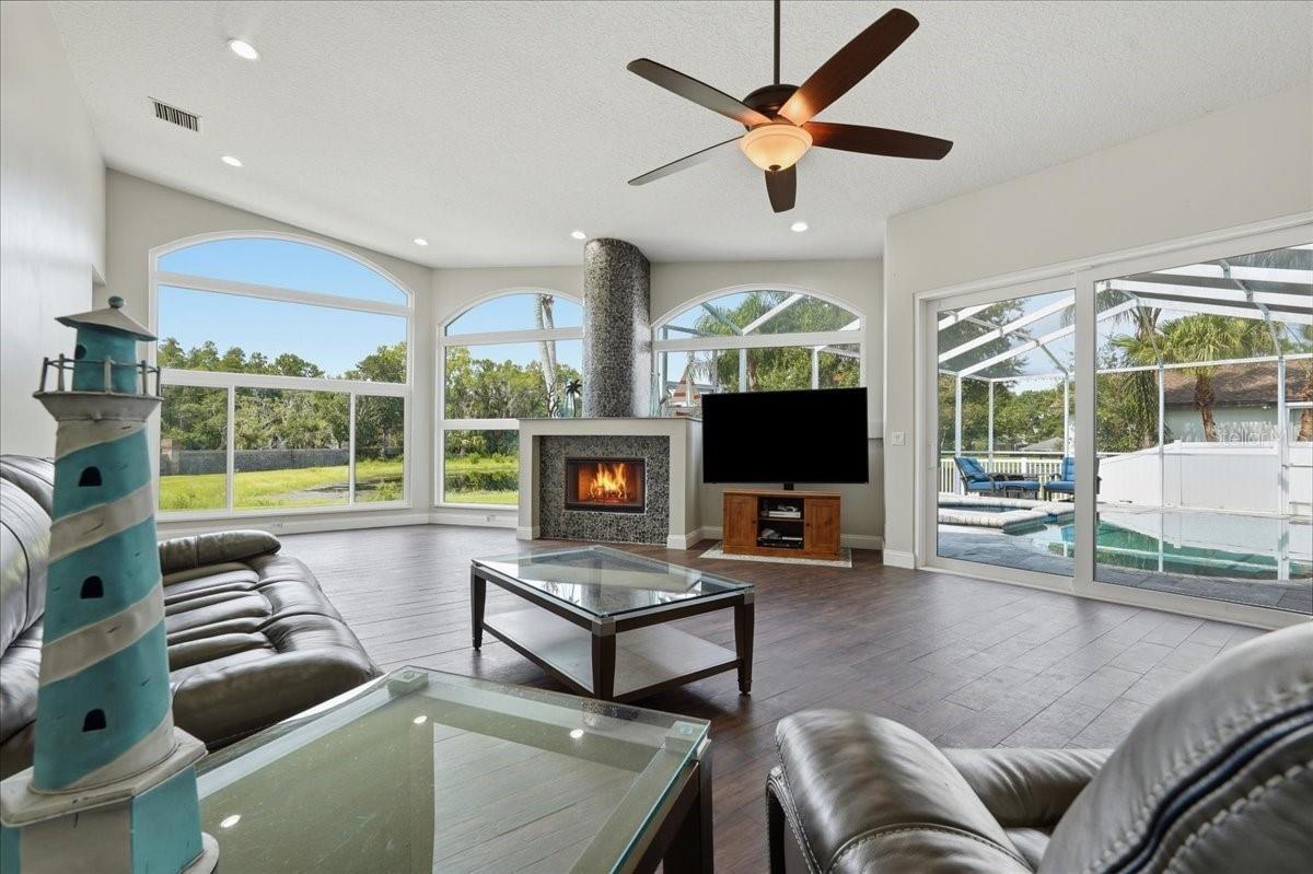 Expansive views of the spring fed pond and pool from the Great Room