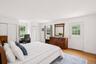 Primary ensuite with access to the lush gardens and unground pool in the backyard.