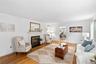 A warm and inviting living room centered around a beautiful fireplace and hardwood floors throughout..