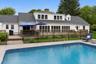 The stunning heated gunite saltwater pool overlooks the lush fairways, creating a private resort style setting.