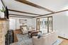 Warm and comfortable great room with wood exposed beams and fireplace for year round relaxation.