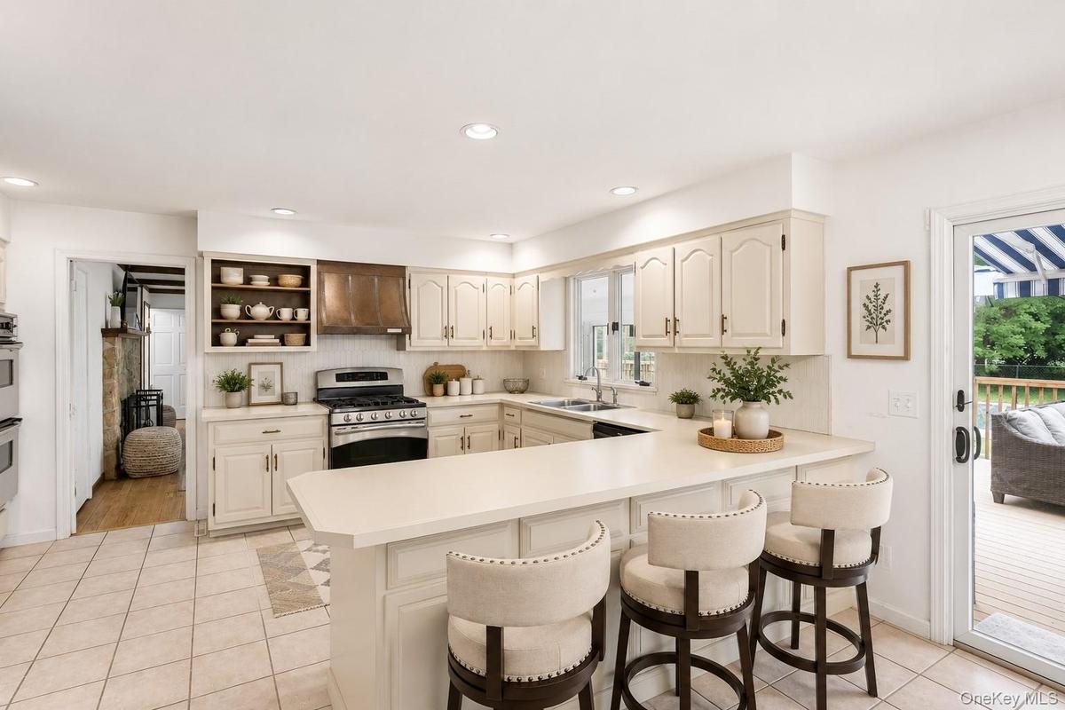 Bright and functional, the kitchen features ample cabinetry, generous workspace and an inviting open layout.