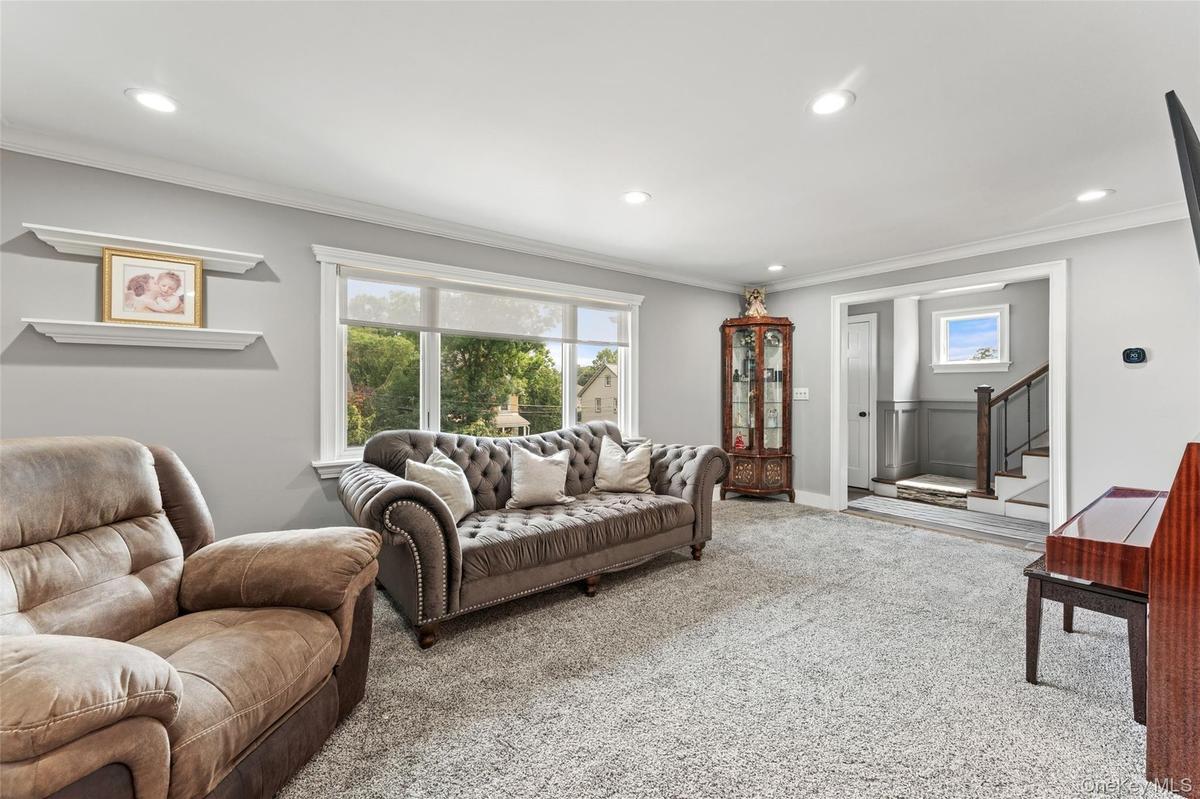 Freshly painted Living room with picture window and recessed lighting.