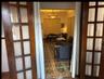 1st floor living/family/greatroom with furniture prior to renovation of floor tiles. French doors on 3 sides allow a very open experience.