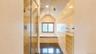 Bathroom featuring a glass-enclosed shower, a built-in soaking tub, tile flooring, recessed lighting, and a frosted window