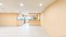 Open-concept living area featuring a kitchen with light wood cabinetry, stainless steel appliances, a breakfast bar, and recessed lighting