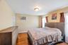 Spacious room featuring wood-finish flooring and a window-mounted air conditioning unit