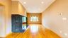 Spacious room featuring wood-finish flooring, recessed lighting, and a built-in dark granite-look fireplace with a hearth