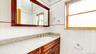 Vanity featuring a built-in sink, chrome faucet, and speckled countertop