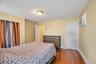 Room featuring wood-finish flooring, a ceiling-mounted light fixture, and a wall-mounted air conditioning unit