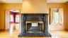 Fireplace featuring a dark granite surround and hearth with a polished brass firebox