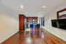 Open-concept living area featuring rich wood-finish flooring and recessed lighting