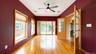 Hardwood flooring throughout this room featuring a ceiling fan, recessed lighting, and two sets of glass-paneled doors