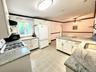 Kitchen featuring extensive white cabinetry, speckled countertops, a gas range, and a ceiling fan