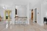 Kitchen pass-through with a stone countertop and dark wood cabinetry