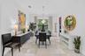 Spacious interior room featuring light-toned tile flooring, recessed lighting, and crown molding