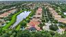 Aerial perspective highlighting a residential property with solar panels and a private pool