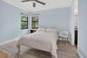 Interior room featuring light blue walls and wood-finish flooring