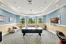 Spacious recreation room featuring an air hockey table, large windows, and recessed lighting