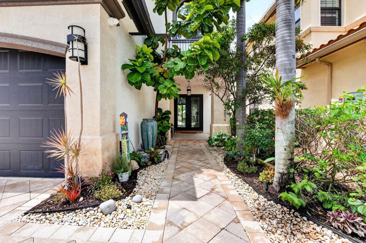 Paver walkway leading to a double-door entry