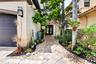 Paver walkway leading to a double-door entry