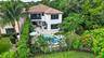 Backyard oasis featuring a freeform swimming pool with integrated spa, surrounded by extensive hardscaping