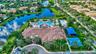 Expansive community amenities including a multi-level resort-style swimming pool, a full-size basketball court, and a covered recreation area, all sit