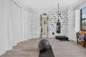 Spacious room featuring light wood-finish flooring and crown molding