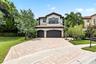 Spanish-inspired two-story residence featuring a tile roof and stucco facade