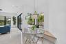 Integrated dining area featuring a built-in bench seating, large corner windows, and a modern pendant light fixture