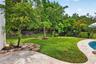 Manicured lawn area with a stone paver patio
