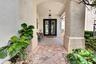 Inviting entry with stone-clad columns and an arched ceiling
