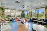 Spacious room featuring panoramic windows, custom muraled walls and ceiling, recessed lighting, and a unique multi-toned flooring design