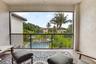 Expansive balcony featuring a black metal railing, textured exterior walls, and tiled flooring