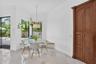Corner dining area featuring large windows, a built-in bench, and a pendant light fixture
