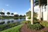 Water feature with a decorative waterfall, surrounded by mature palm trees and lush landscaping