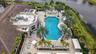 Expansive pool area featuring a freeform swimming pool, integrated fountain, and a circular spa
