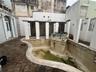 Original pool and spa design had trellises and a waterfall wall. It will require full renovation.