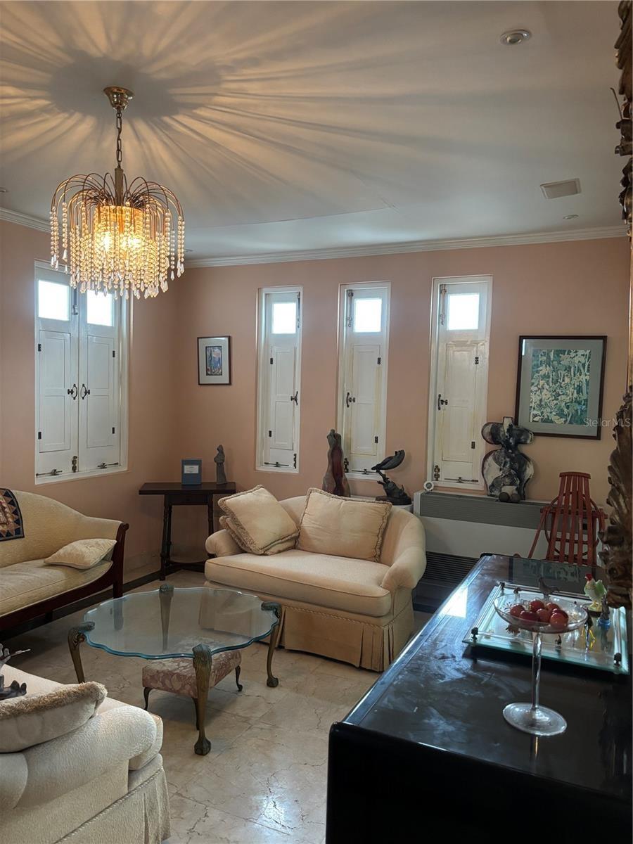 Living Room with marble floors leads to dining room on the right and family/bonus room to the left.