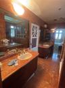 Primary Bathroom with two separate vanities and unique red marble.
