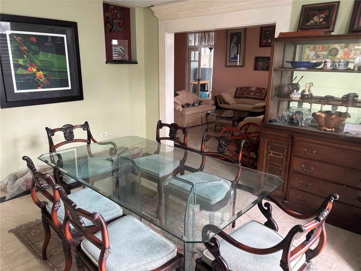 The formal Dining Room has French Doors that lead to the backyard gardens, pool and spa area.