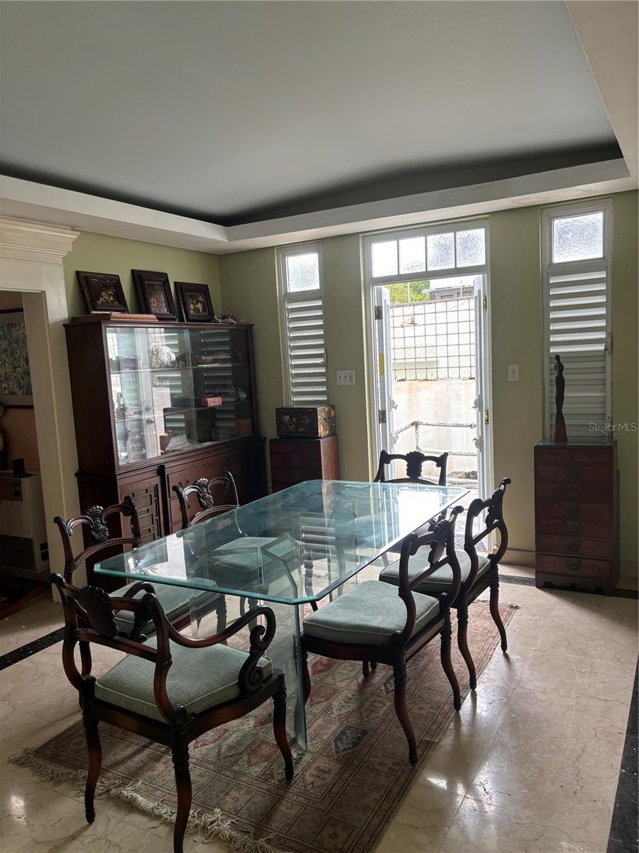 Formal Dining Room with doors to the back yard gardens.