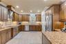 wood cabinets, granite countertops, tile backsplash